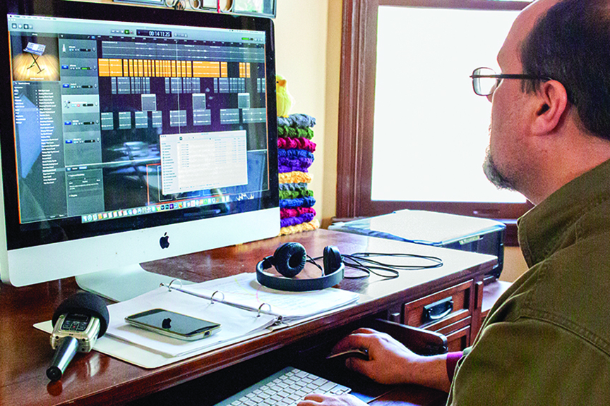Man does film production work on a computer