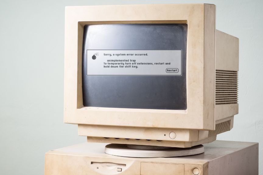 Dusty old Apple computer showing system error screen