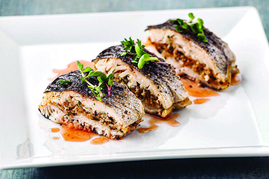 elegantly plated almond -stuffed rainbow trout