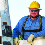 Arkansas Lineman poses for the camera after working on a utility pole.