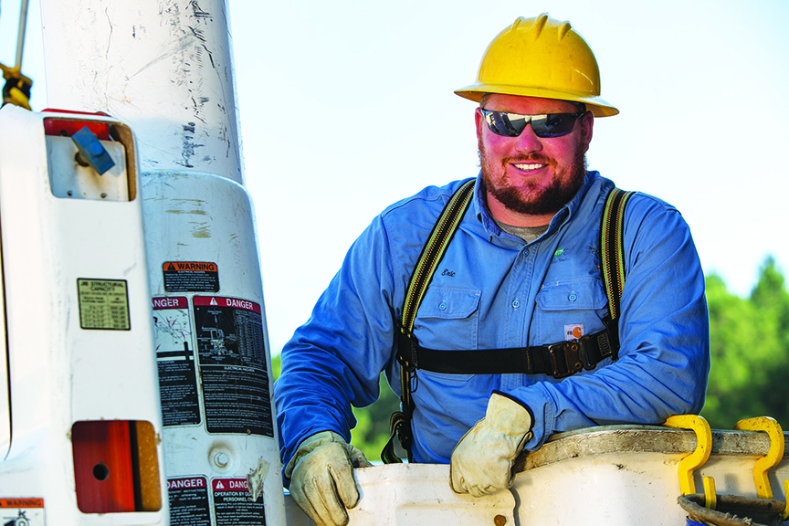 Arkansas Lineman poses for the camera after working on a utility pole.