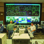 People are at work in a grid data operations center
