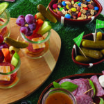 Several party foods and snacks, with football-themed decor