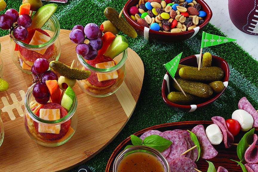 Several party foods and snacks, with football-themed decor