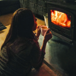 Woman in front of woodstove