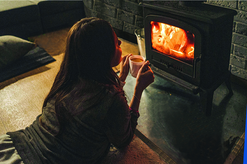 Woman in front of woodstove