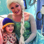 Woman dressed as ice queen poses with child in hospital