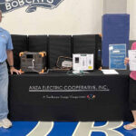 Anza Electric Cooperative General Manager Kevin Short and Member Service Rep Betsy Hansen next to solar-powered batteries distributed by the co-op to members requiring dialysis and oxygen concentrators.