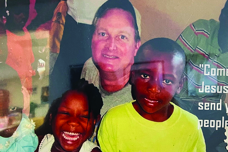 Dave Simpson surrounded by children