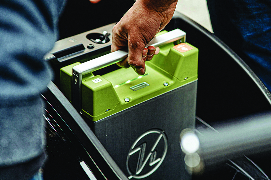 Man holds a lithium-ion battery, like one used in an electric vehicle