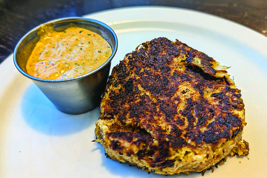 Crab cake served with dipping sauce