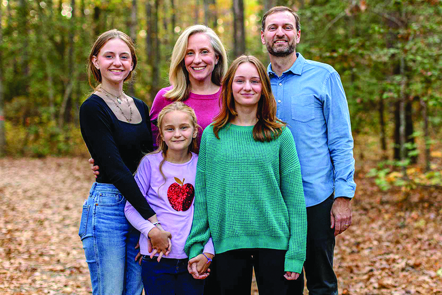 Abigail Spanberger poses outdoors with husband and three daughters.