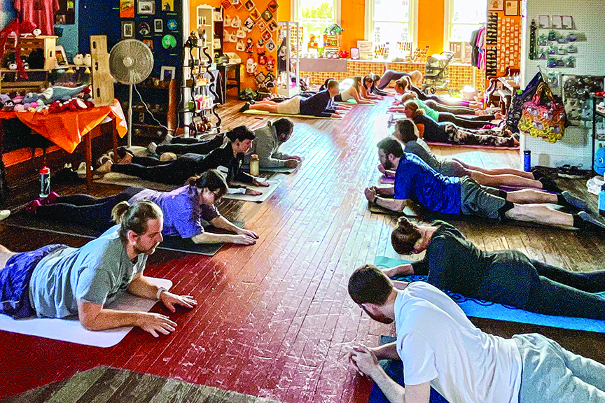 Group does yoga at Possum-bilities gift shop in Fredericksburg