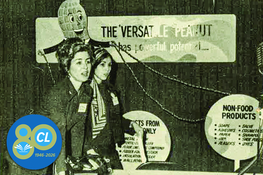 The director of Growers Peanut Food Promotions pauses with a representative of the Virginia Department of Agriculture and Commerce during a peanut festival in Franklin, Va., 1971. 