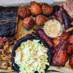 Platter of barbecued meats and cole slaw