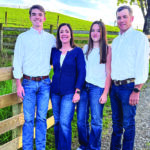 Sarah Wilson stands with her husband, Adam, and their children, Clint and Mady, on the family's farm