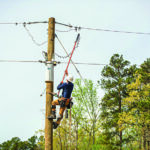 A student uses a hot stick in a training exercise that simulates working safely with energized equipment.