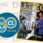 A graphic is set against a background patterned with a repeating "RURAL LIVING" logo. On the left is a blue circular badge featuring a large gold numeral "80," a smaller white circle with the letters "CL," and the years "1946–2026." On the right, an image of a magazine cover titled "rural Living" from October 1996 marked "50th Anniversary Issue." The magazine cover shows a mail carrier from 1946 in uniform handing a magazine to a smiling Black woman in a blue blazer representing 1996, with the headline "Home Delivered for 50 Years."