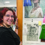 Student poses with art entries at the Virginia State Fair