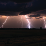 the sky fills with streaks of lightning above a darkened prairie, Generative AI