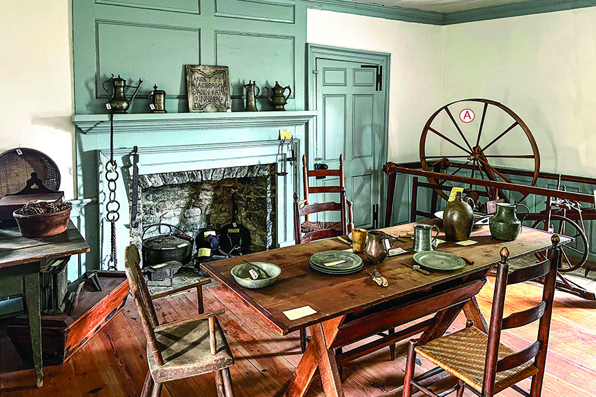 Recreation of a Revolutionary-era room with rustic dining table and chairs and other household items of the era