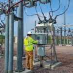 A man checks up on a local cooperative substation.